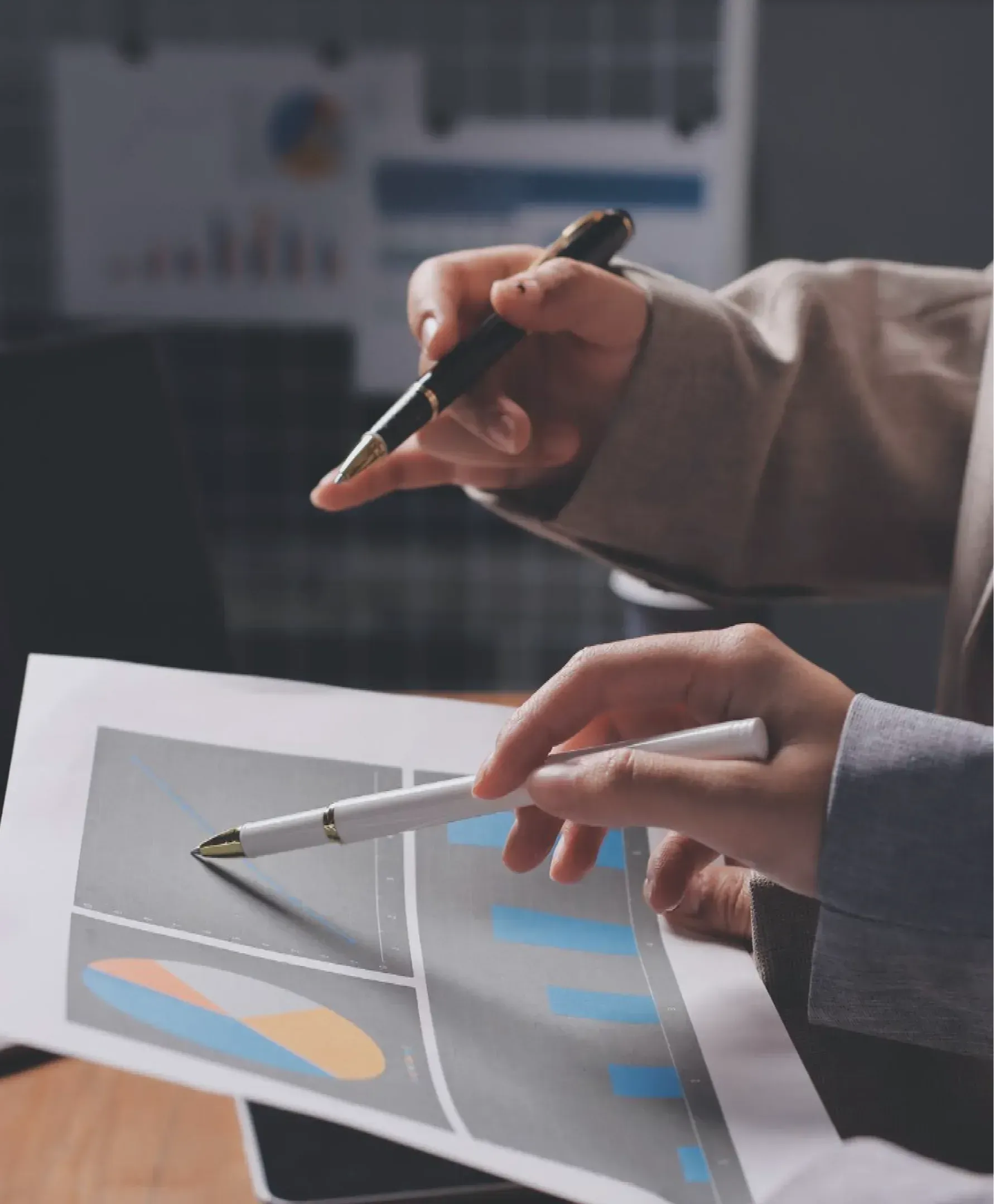 People point to a graphs on a report