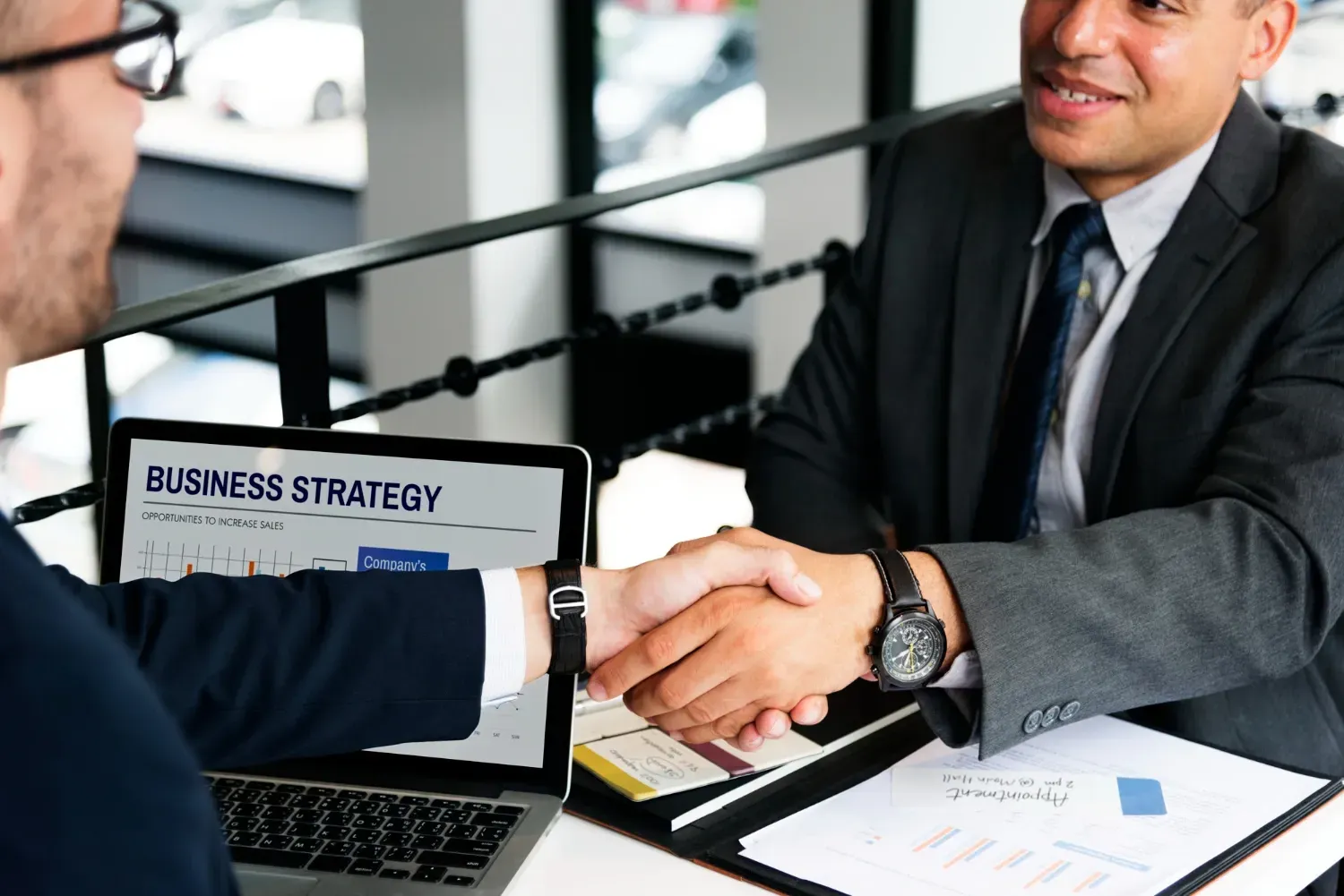 Business owner reviewing financial documents with a CPA while preparing to sell a business.
